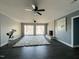 Spacious living room featuring a fireplace, ceiling fans, and access to the outdoors at 11813 Edgewater Ct, Raleigh, NC 27614