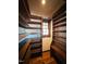 Walk-in pantry featuring wooden shelving, hardwood floors, and a window providing natural light at 11813 Edgewater Ct, Raleigh, NC 27614