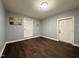 Versatile room featuring dark wood floors and multiple doorways at 11813 Edgewater Ct, Raleigh, NC 27614