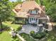 An aerial view shows the house, screened in porch, fireplace, back patio, and surrounding greenery at 1225 Fanning Dr, Wake Forest, NC 27587