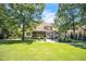 Spacious backyard with manicured lawn and large mature trees at 1225 Fanning Dr, Wake Forest, NC 27587