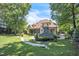 Backyard featuring mature trees, outdoor fireplace, and playset at 1225 Fanning Dr, Wake Forest, NC 27587