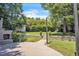 Large backyard featuring stone fireplace, playset, and grassy area at 1225 Fanning Dr, Wake Forest, NC 27587