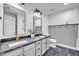 Bright bathroom featuring a double vanity with black marble, modern fixtures, and a walk-in shower at 1225 Fanning Dr, Wake Forest, NC 27587