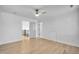 Bright bedroom featuring hardwood floors, ceiling fan, and closet access, plus white trim at 1225 Fanning Dr, Wake Forest, NC 27587