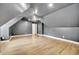 Attic bedroom with gray walls, hardwood flooring, ceiling fan, and a bonus room at 1225 Fanning Dr, Wake Forest, NC 27587