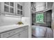 Gray butler's pantry with hardwood floors, granite countertops and bright lighting at 1225 Fanning Dr, Wake Forest, NC 27587