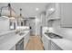 Bright kitchen featuring stainless steel appliances, modern white cabinets, and a marble countertop at 1225 Fanning Dr, Wake Forest, NC 27587