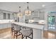 Stylish kitchen with white cabinets, stainless steel appliances, marble countertops, and pendant lighting at 1225 Fanning Dr, Wake Forest, NC 27587