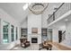 Bright, open floor plan living room with high ceilings, large windows, and fireplace at 1225 Fanning Dr, Wake Forest, NC 27587
