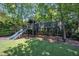 Backyard wooden playset features swings, slide, and lookout tower at 1225 Fanning Dr, Wake Forest, NC 27587