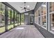 Bright sunroom features many windows, grey walls, and wood flooring at 1225 Fanning Dr, Wake Forest, NC 27587