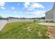 Backyard features a white picket fence, a lush lawn, and a peaceful spot for relaxation at 1303 Bent Willow Dr, Durham, NC 27704