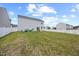 Expansive backyard featuring a lush lawn, white picket fence, and relaxing hammock area at 1303 Bent Willow Dr, Durham, NC 27704