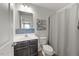 Bathroom features a mosaic tile backsplash, shower with curtain and wood look flooring at 1303 Bent Willow Dr, Durham, NC 27704