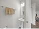 Cozy half bath with pedestal sink, decorative mirror and towel bar at 1303 Bent Willow Dr, Durham, NC 27704