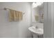 Half bathroom has pedestal sink, mirror, towel rack and paper holder at 1303 Bent Willow Dr, Durham, NC 27704