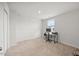 Neutrally decorated bedroom featuring plush carpeting, a ceiling light, and a window for natural light at 1303 Bent Willow Dr, Durham, NC 27704