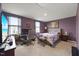 Bedroom with purple walls, carpeted floors, television, and a workstation by the window at 1303 Bent Willow Dr, Durham, NC 27704
