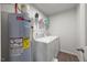 Functional laundry room with washer, dryer, water heater and added shelving at 1303 Bent Willow Dr, Durham, NC 27704
