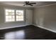 Well-lit living room with sleek wood floors and a neutral color palette at 157 Thorpe St, Henderson, NC 27536