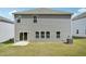 Rear view of a home, concrete patio, sliding glass doors, windows, and an air conditioning unit at 1730 Pie Filling Dr, Haw River, NC 27258