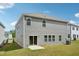 Rear view of a home showing siding, concrete patio, sliding glass doors, and windows at 1730 Pie Filling Dr, Haw River, NC 27258