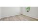 Bedroom with wood-look floors and a window showing a view of the neighborhood at 1730 Pie Filling Dr, Haw River, NC 27258