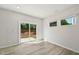 Bright bedroom featuring light wood floors, recessed lighting, and a sliding glass door leading to the backyard at 1730 Pie Filling Dr, Haw River, NC 27258