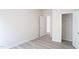 View of bedroom with neutral paint, leading to an open door and a closet at 1730 Pie Filling Dr, Haw River, NC 27258