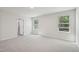 Bright bedroom featuring two windows and neutral carpet at 1730 Pie Filling Dr, Haw River, NC 27258