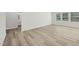 Bright bedroom featuring wood-look floors, neutral paint, large windows, and ample closet space at 1730 Pie Filling Dr, Haw River, NC 27258