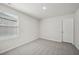 Carpeted bedroom with a window and a door at 1730 Pie Filling Dr, Haw River, NC 27258