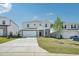 Charming two-story home boasts a well-manicured lawn, inviting driveway, and attached two car garage at 1730 Pie Filling Dr, Haw River, NC 27258