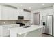 Contemporary kitchen boasting white cabinets, stainless steel appliances, and a spacious island with a sink at 1730 Pie Filling Dr, Haw River, NC 27258