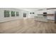 A modern kitchen blends seamlessly with the living space with stainless steel appliances and wood look floors at 1730 Pie Filling Dr, Haw River, NC 27258