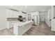 Well-lit kitchen with white cabinetry, stainless steel appliances, and a central island with a sink at 1730 Pie Filling Dr, Haw River, NC 27258