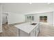 Open-concept kitchen and living area featuring a white kitchen island with a sink and modern appliances at 1730 Pie Filling Dr, Haw River, NC 27258
