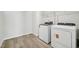 Functional laundry area with modern washer and dryer, plus storage shelving at 1730 Pie Filling Dr, Haw River, NC 27258