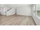 Spacious living room boasts sleek floors, recessed lighting, neutral paint, and ample natural light at 1730 Pie Filling Dr, Haw River, NC 27258