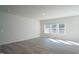 Bright living room featuring hardwood floors and large windows that bring in plenty of natural light at 1730 Pie Filling Dr, Haw River, NC 27258