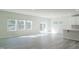 Open living space featuring light-colored floors, ample windows, and access to the kitchen at 1730 Pie Filling Dr, Haw River, NC 27258
