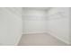 Spacious walk-in closet with carpet flooring and white shelving units at 1730 Pie Filling Dr, Haw River, NC 27258
