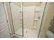 Modern shower with glass doors, built in shelves, a shower head, and an attached toilet at 1940 Dunfield Dr, Fuquay Varina, NC 27526