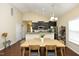 Dining area with a wooden table and stylish chairs, adjacent to the kitchen, perfect for Gathering meals at 1940 Dunfield Dr, Fuquay Varina, NC 27526