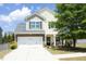 Charming two-story home with a well-manicured lawn, a two car garage and a welcoming front porch at 1940 Dunfield Dr, Fuquay Varina, NC 27526