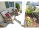 Cozy front porch with wicker chairs and decorative pillows surrounded by lush landscaping at 1940 Dunfield Dr, Fuquay Varina, NC 27526