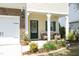 Inviting front porch with comfortable seating and decorative plants, creating a warm entrance at 1940 Dunfield Dr, Fuquay Varina, NC 27526