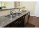 Granite countertops in the kitchen with stainless steel dishwasher, sink, and faucet at 1940 Dunfield Dr, Fuquay Varina, NC 27526