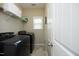 This laundry room features a modern washer and dryer set, shelving, and ample lighting at 1940 Dunfield Dr, Fuquay Varina, NC 27526